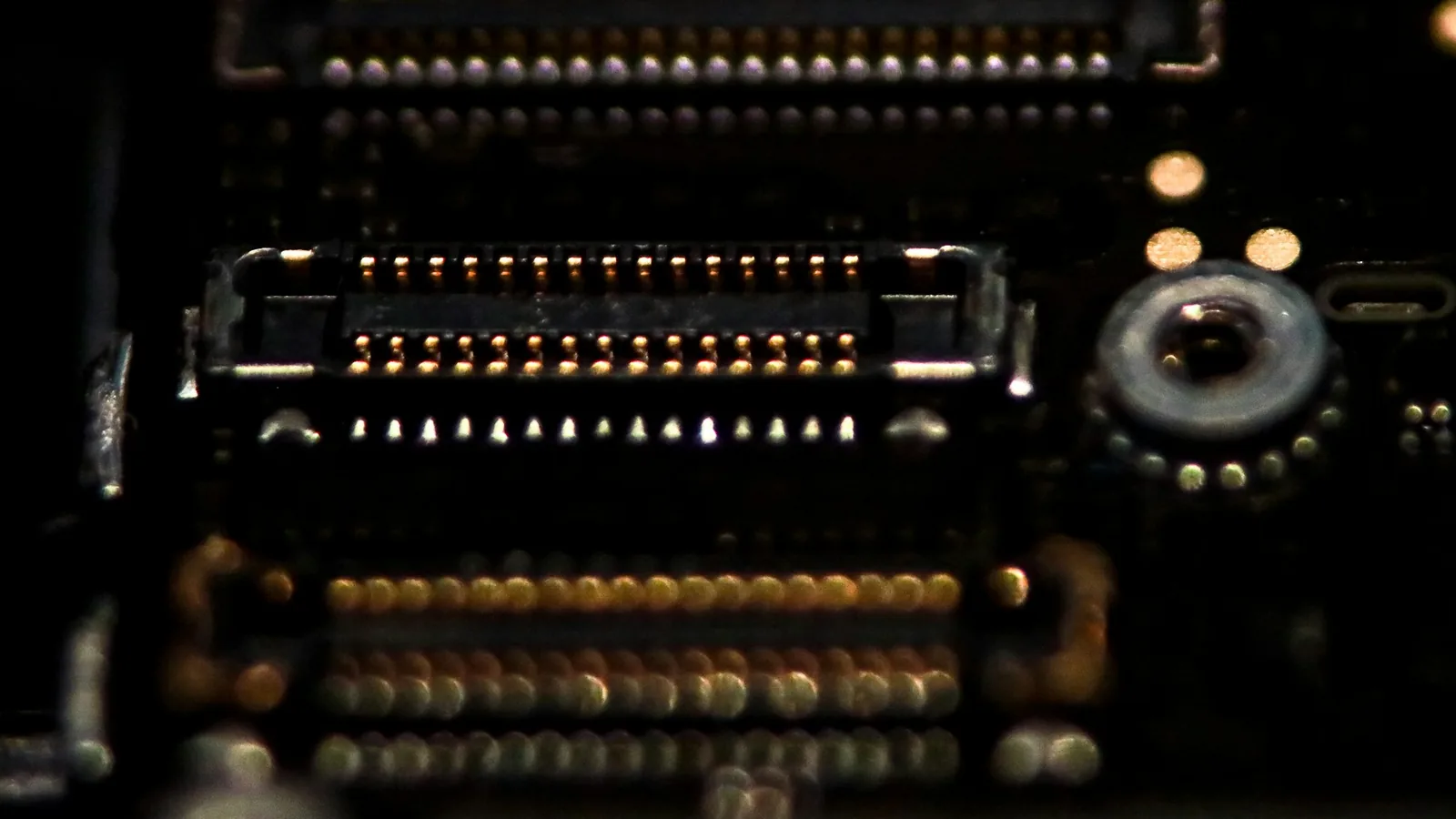 Rows of gold connector pins on a dark circuit board